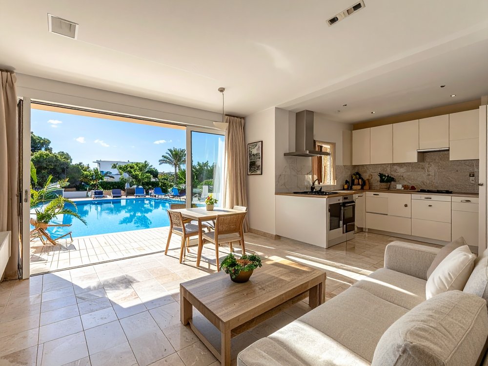 A sunny apartment with a kitchenette and pool views in Cala Millor. AI-generated image.