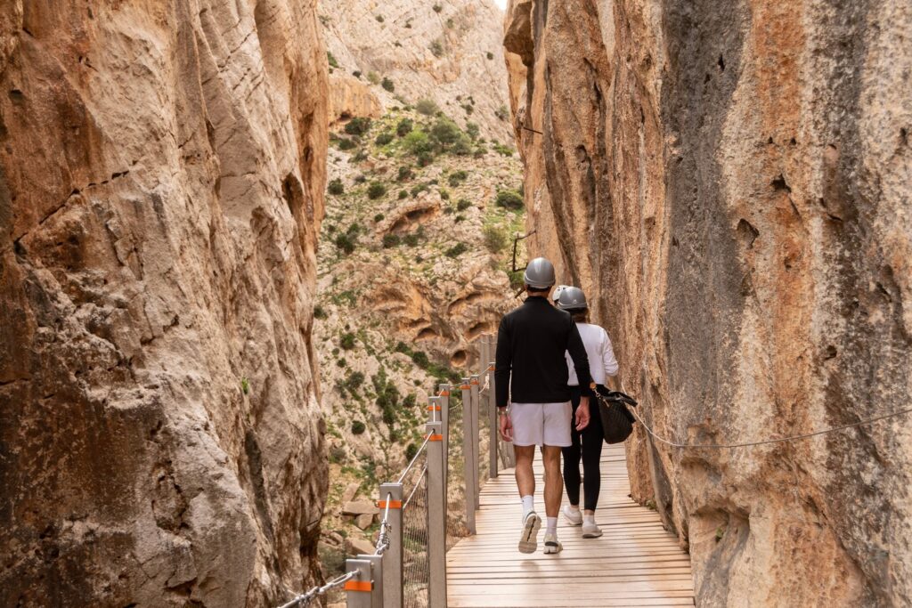 The boardwalk squeezes between the towering rock walls of the Gaitanejo Gorge at the start of the Caminito del Rey