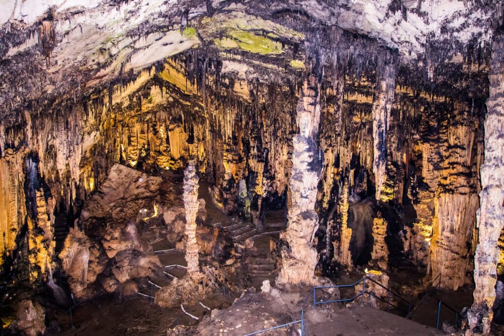 Giant columns and stalactites fill the vast halls of the Caves of Artà above Canyamel Bay