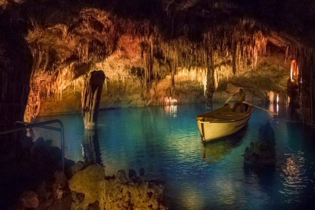 Small boats wait on Lake Martel in the Caves of Drach, where the underground concert ends with a short crossing