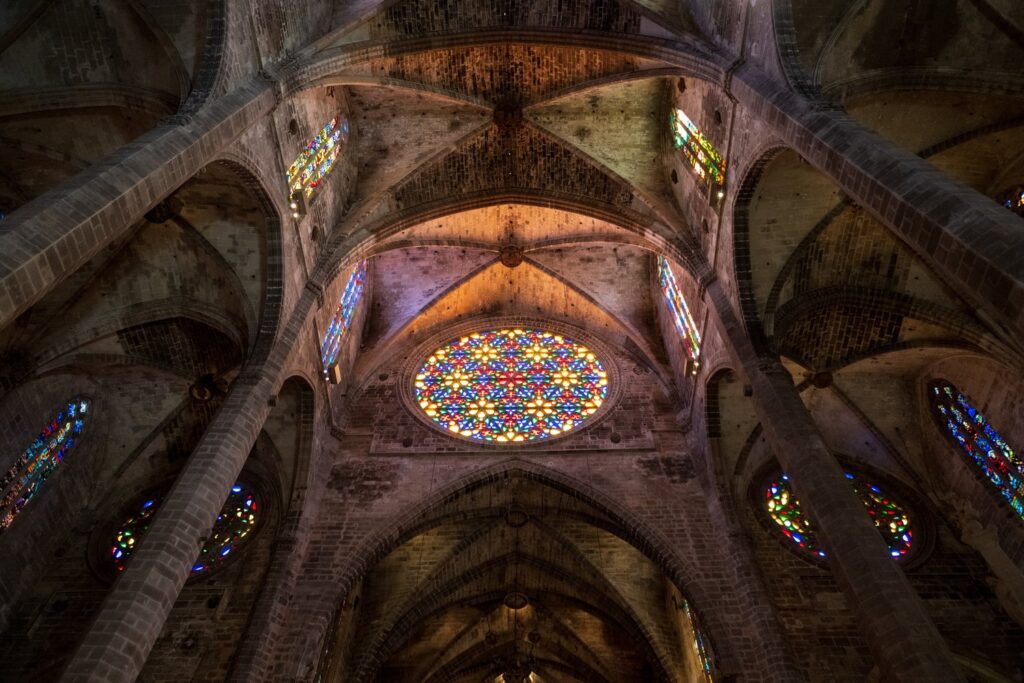 The great rose window glows above the Gothic vaults of La Seu.