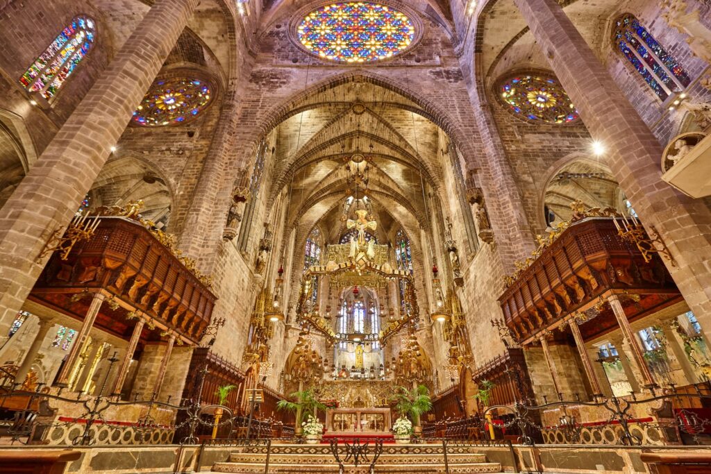 Gaudí's canopy hangs above the altar in the Royal Chapel, framed by the choir stalls.