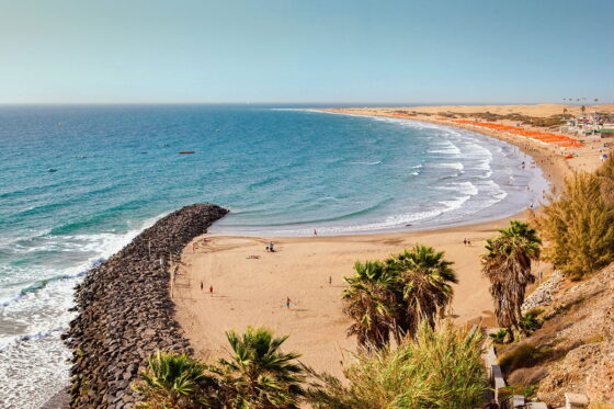 A stunning view of the crystal clear waters and sandy beaches of Gran Canaria