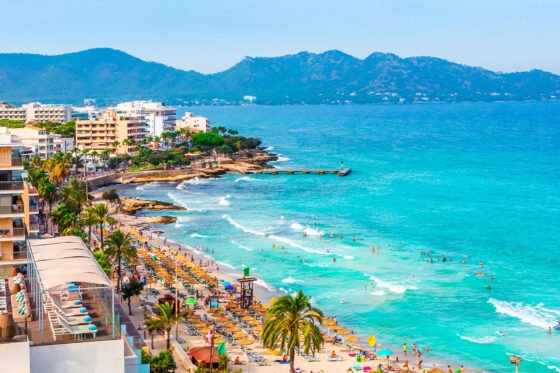 A stunning view of the crystal clear waters and white sandy beaches of Mallorca, perfect for a safari zoo mallorca coastal adventure