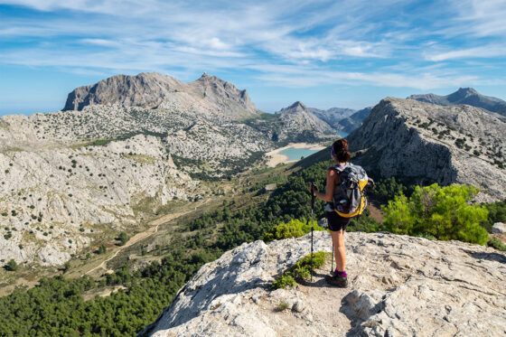 A hiker enjoying the views of the Serra de Tramuntana mountain range in Mallorca, Spain