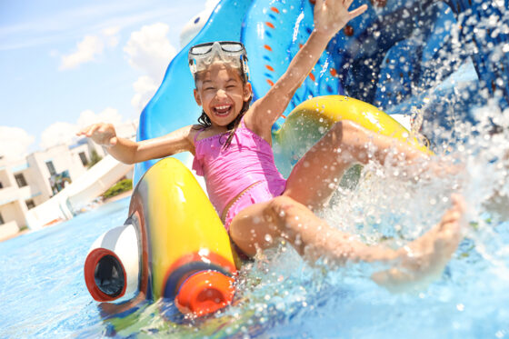 A girl enjoying water slides in the water park in Majorca