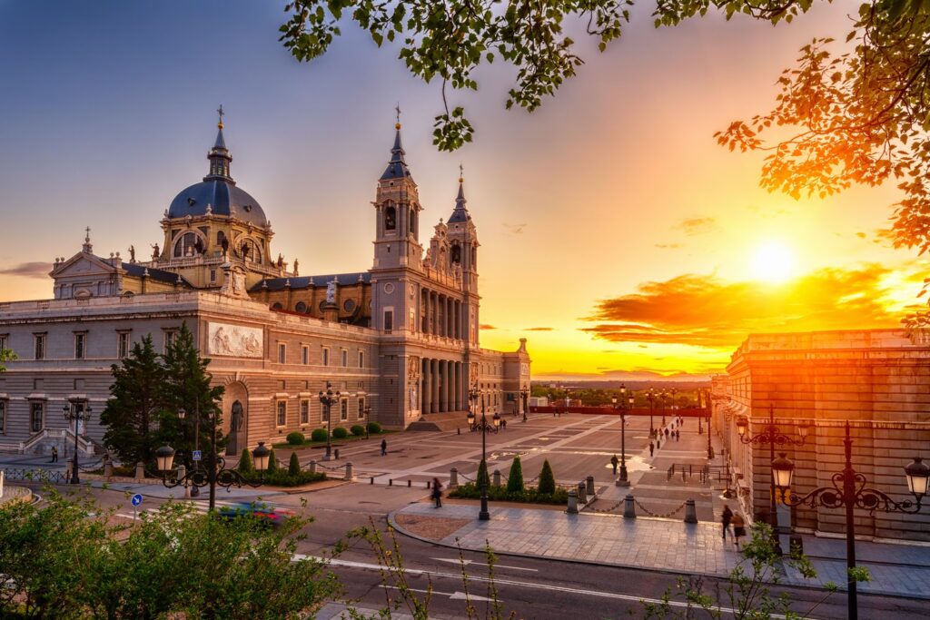 Almudena Cathedral stands next to the Royal Palace and catches the last light of the day.