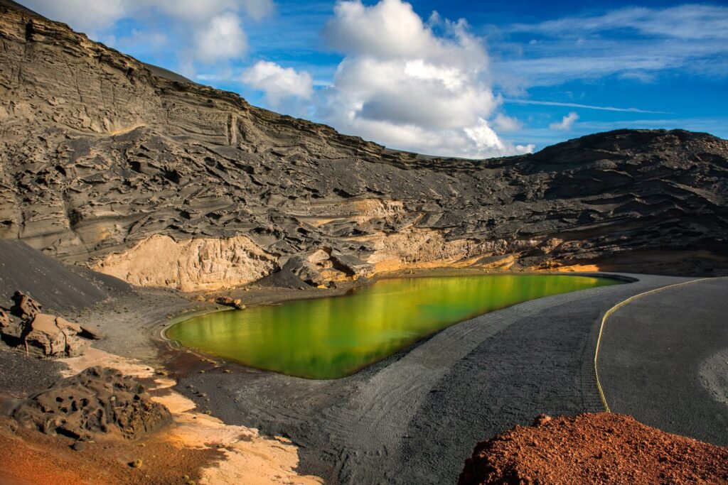 The green lagoon of Charco de los Clicos lies inside a half-sunken crater at El Golfo