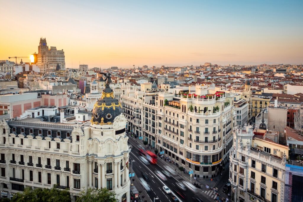 In spring and autumn, warm evenings light up Gran Vía and the rooftops of central Madrid.