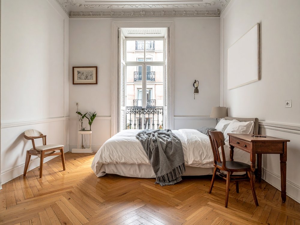 Bright room with a balcony in a 19th-century building in central Madrid. AI-generated image.