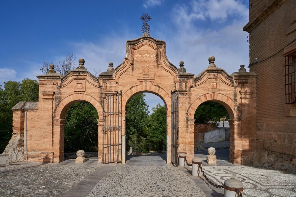 An arched gateway leads to the Sacromonte Abbey above the cave quarter