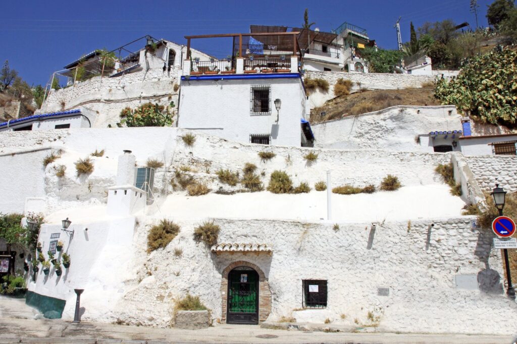 Whitewashed cave houses are still dug into the Sacromonte hillside in Granada