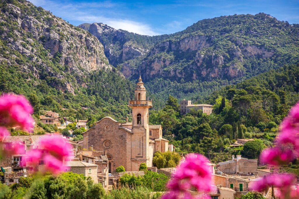 The Church of Sant Bartomeu and the stone houses of Valldemossa sit at the foot of the Serra de Tramuntana mountains