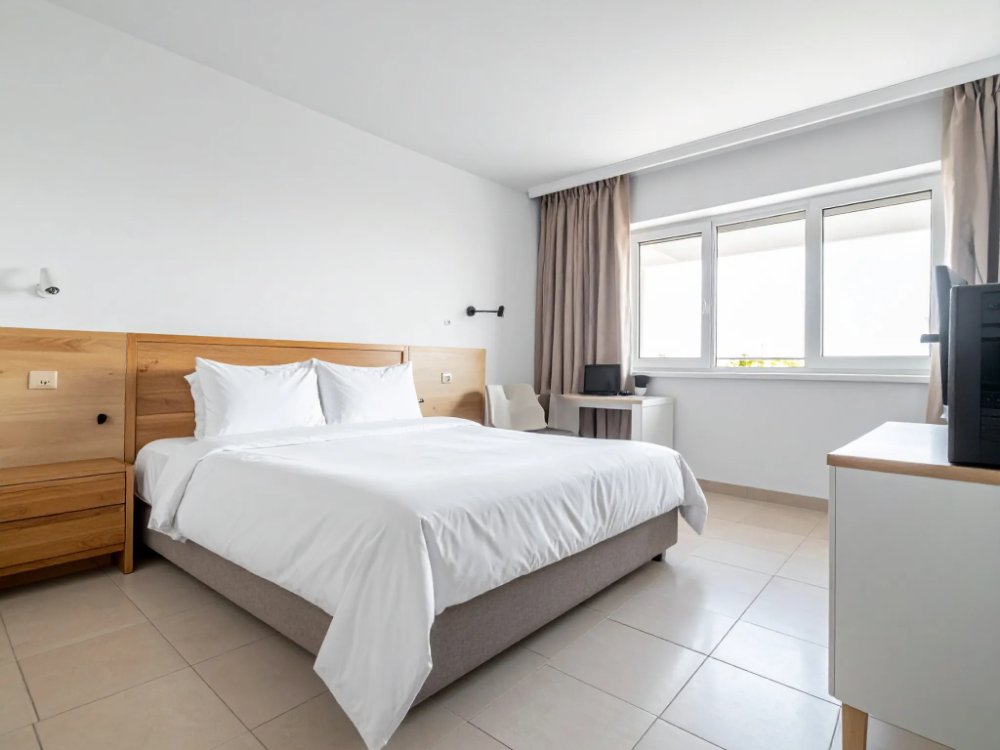 A small, simple hotel room in central Villajoyosa. AI-generated image.